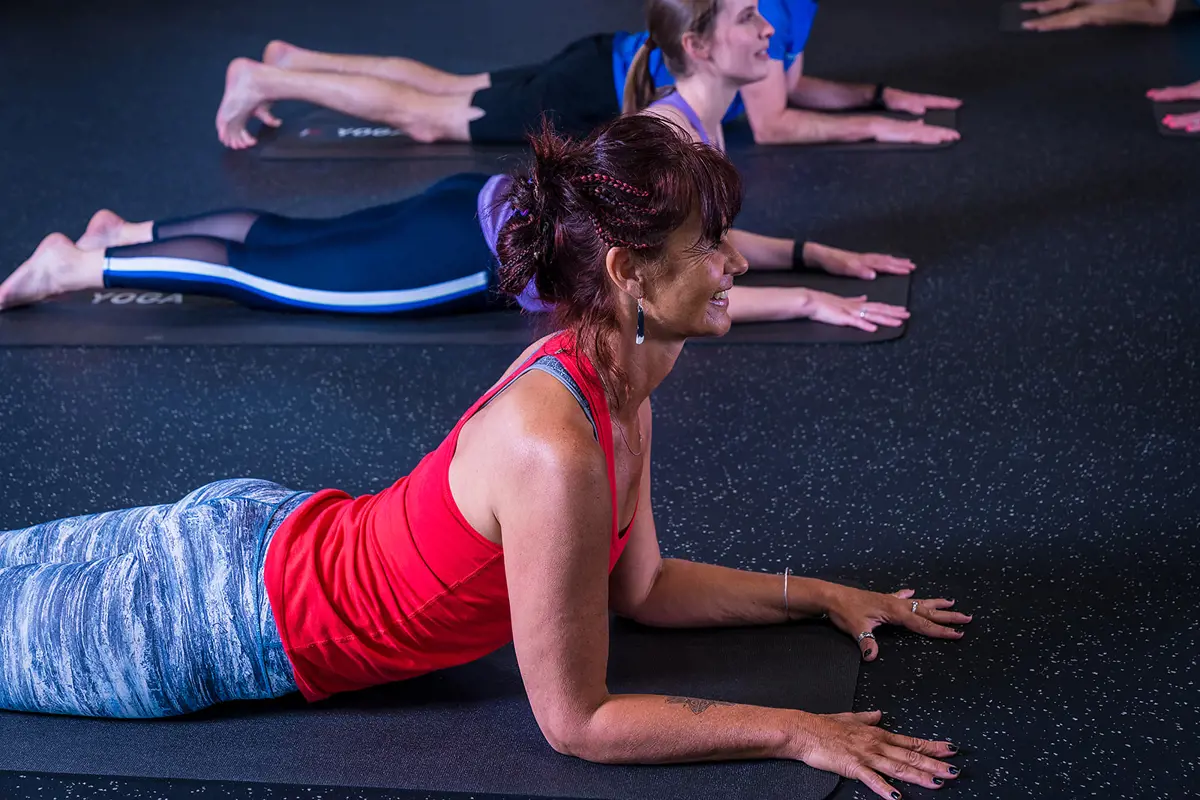 A group of women and men participating in a gentle yoga class at Christchurch Recreation and Sport.