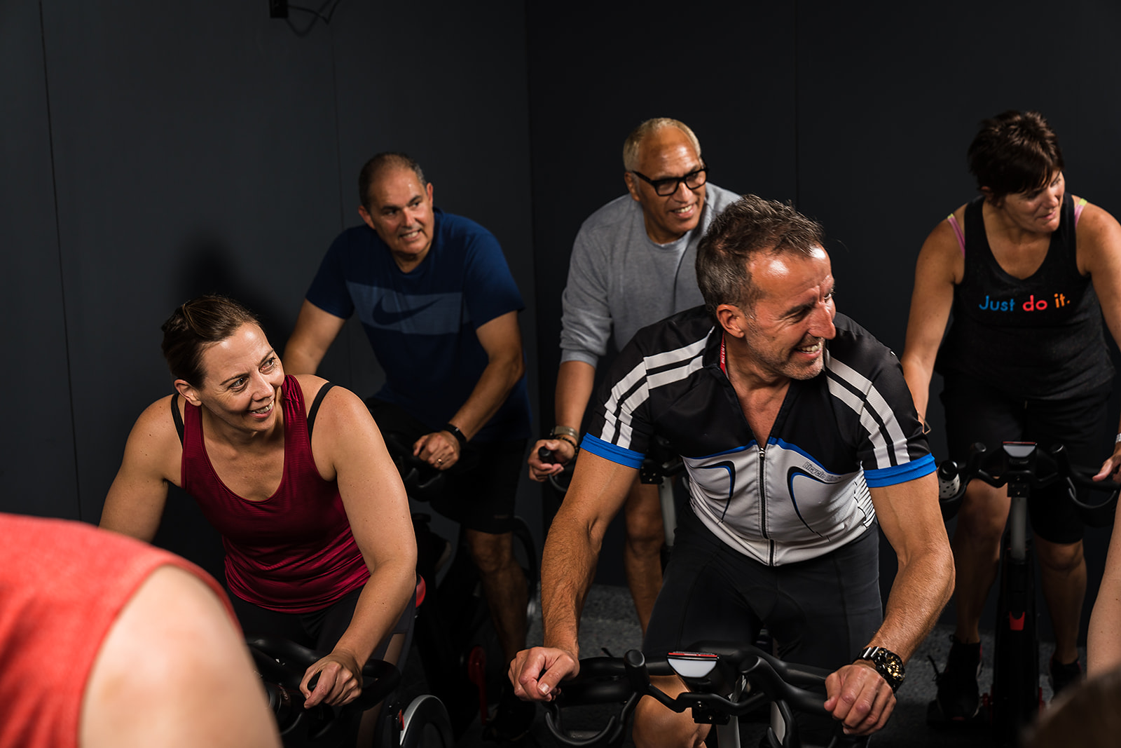 A group of men and woman participating in a spin workout class at Taiora QEII Recreation and Sport pool. 