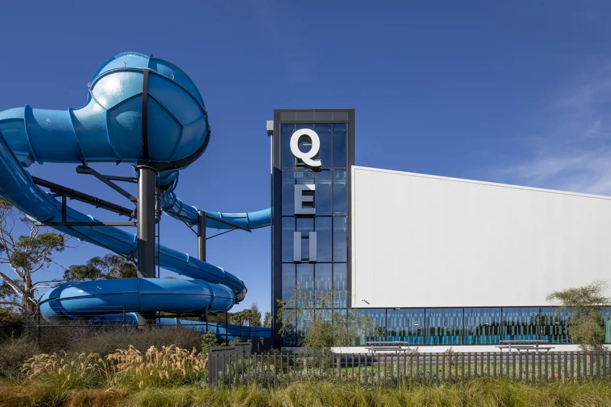 The outside of Taiora QEII Recreation and Sport centre with the blue hydroslide wrapping around the side.