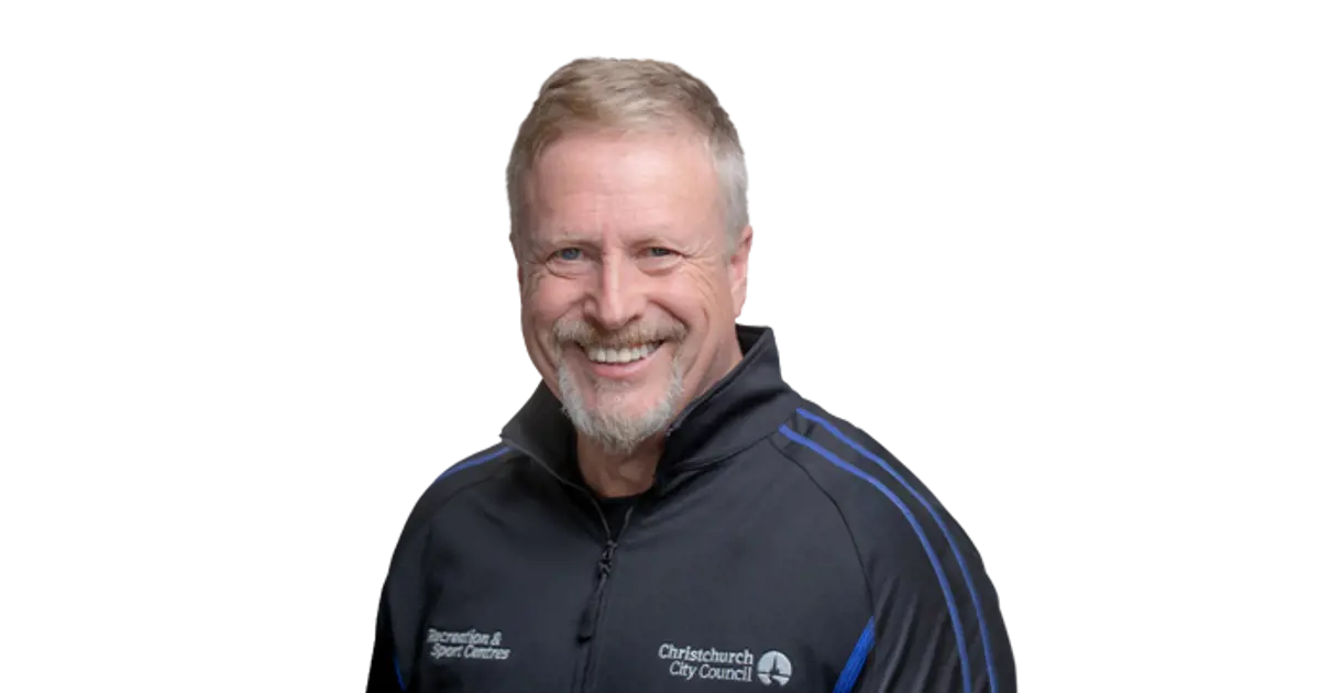 Smiling Personal Trainer, Stuart Dallow wearing and blue and black staff uniform.