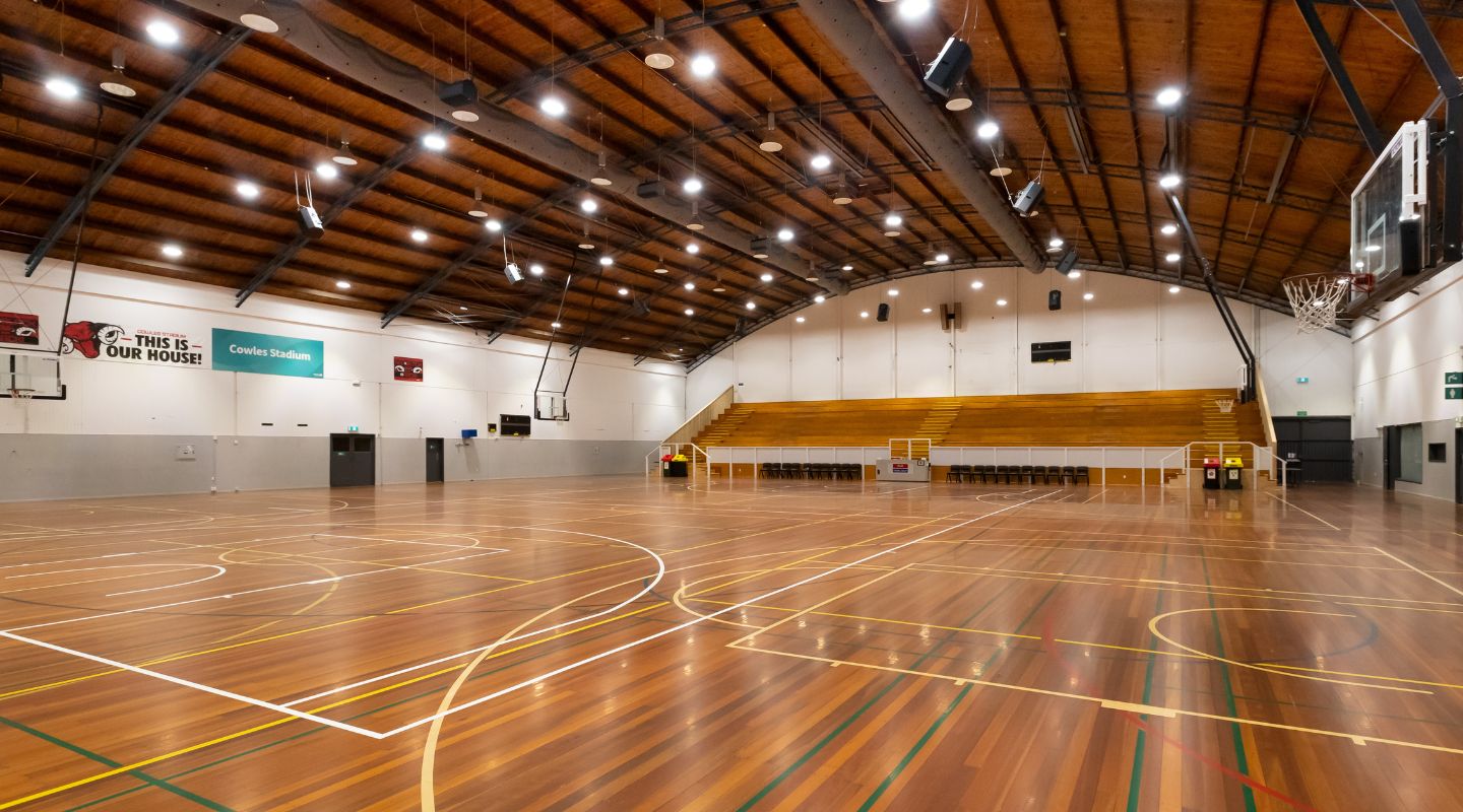 Cowles stadium court with wooden bleachers.
