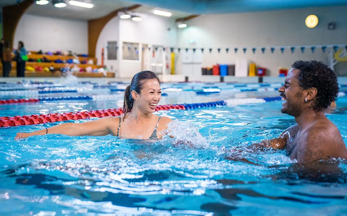 Two smiling people in the lane pool at Christchurch Recreation and Sport pool.